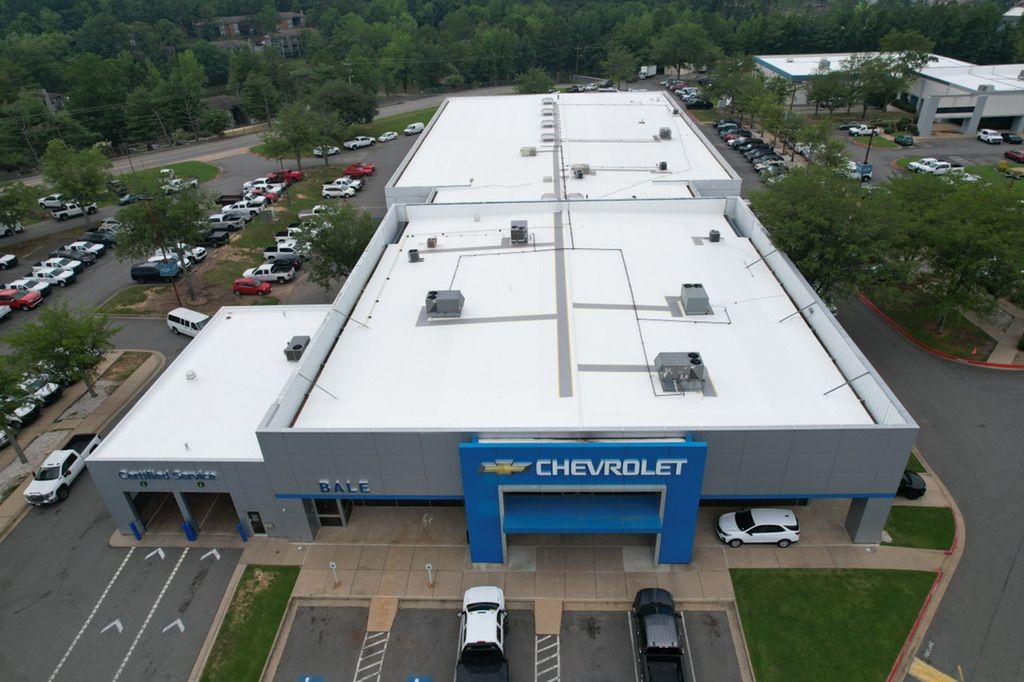 An aerial view of a chevrolet dealership with cars parked in front of it
