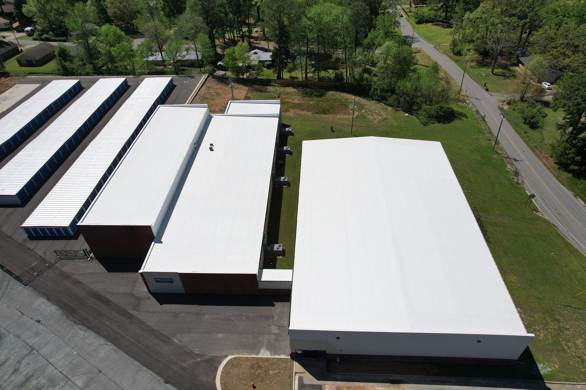 An aerial view of a building with a white roof