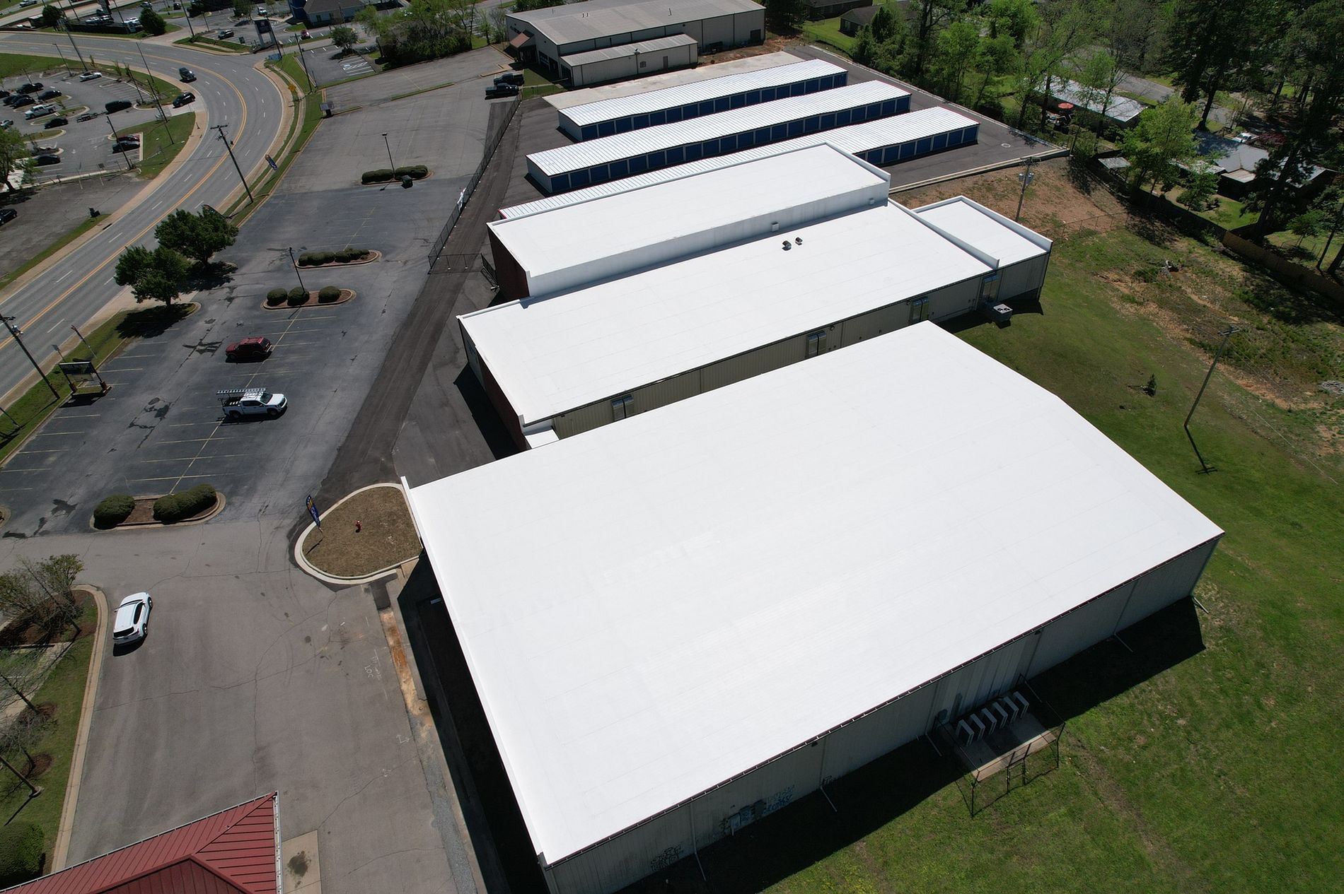 An aerial view of a building with a white roof