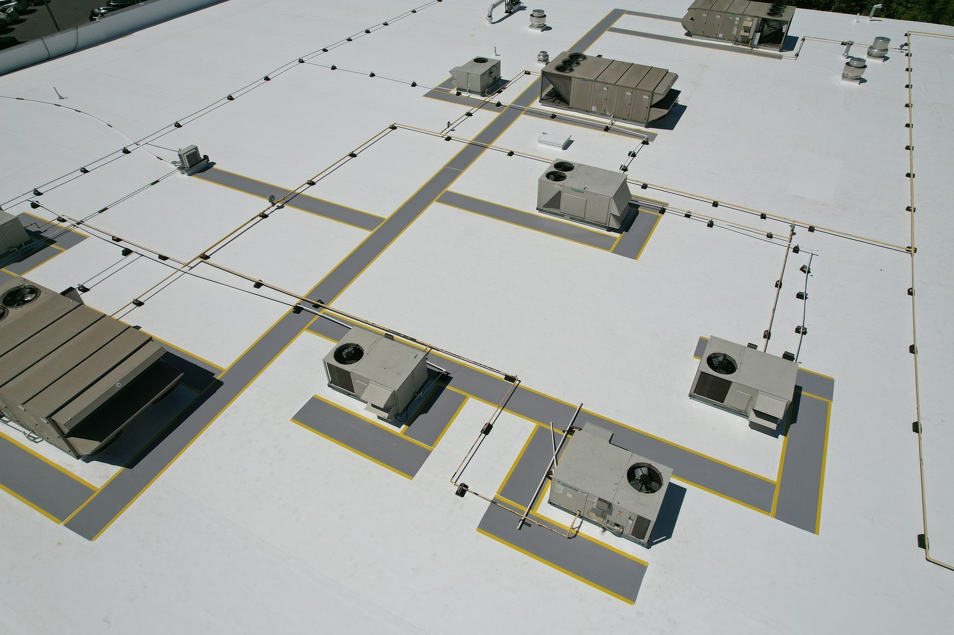 An aerial view of a roof with a lot of air conditioners on it
