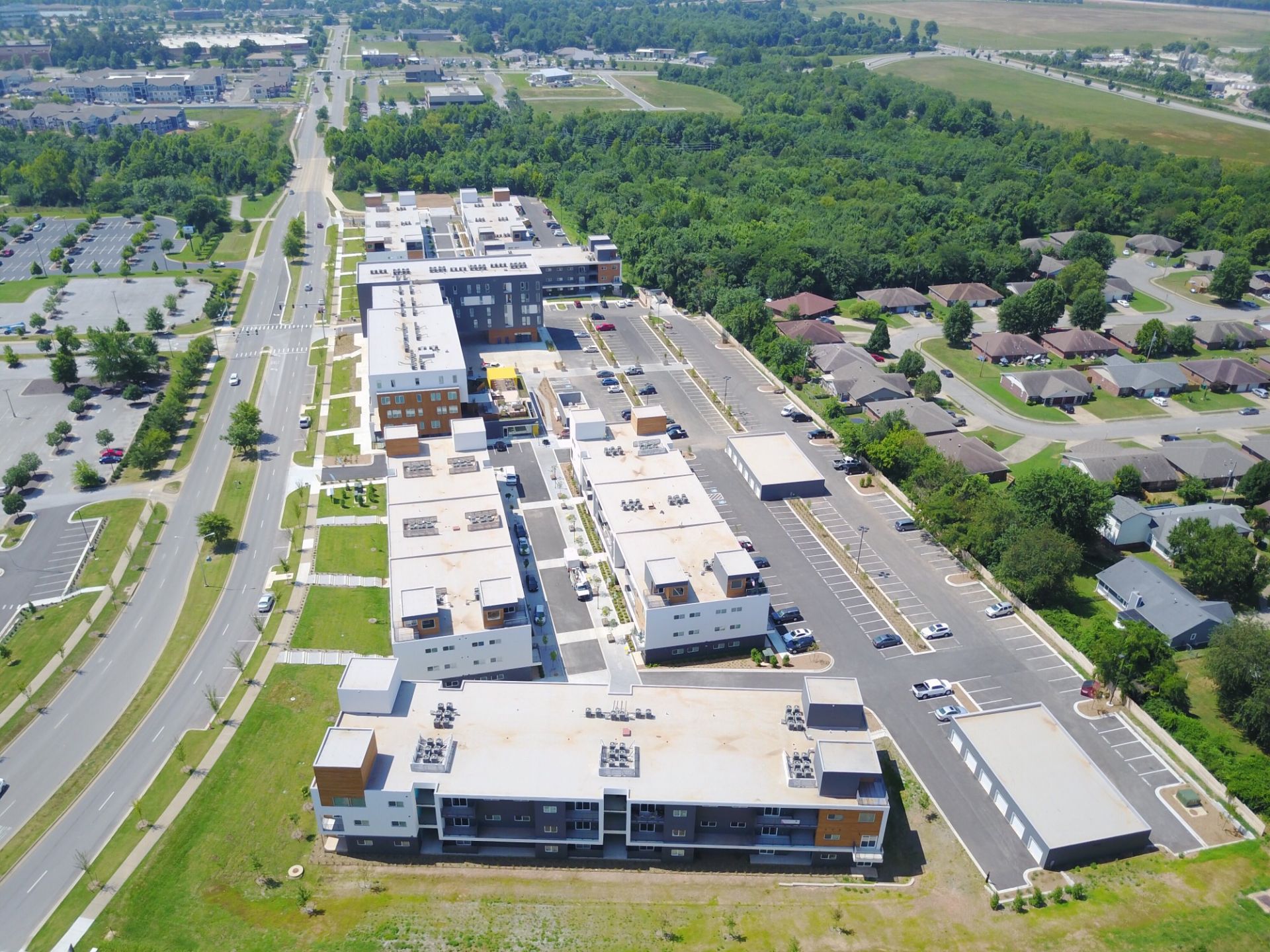 An aerial view of a residential area with a large building in the middle
