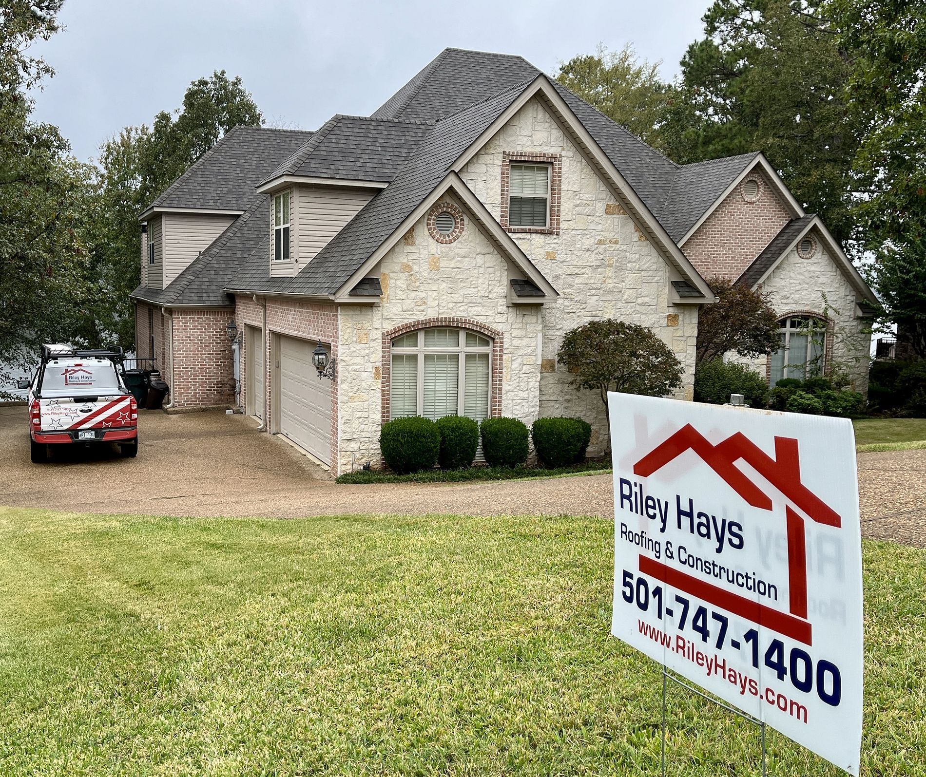 A large house with a sign in front of it.