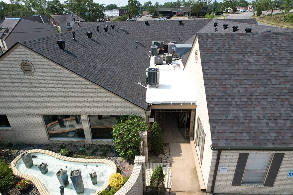 An aerial view of a house with a white roof