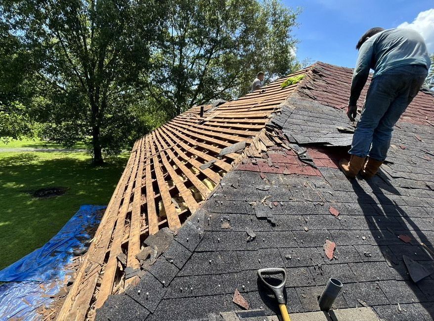 Storm-damaged roof before repair by Riley Hays Roofing